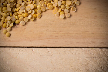 Soybean seed placed a corner on a wooden floor, flay lay with copy space.