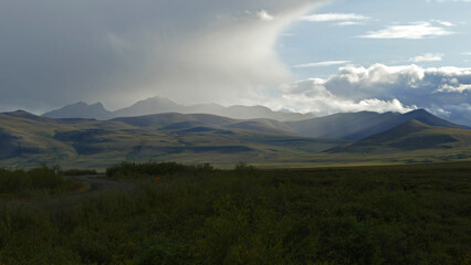 Fototapeta na wymiar Arctic tundra rugged landscape with afternoon shower along Dempster Highway, Yukon, Canada