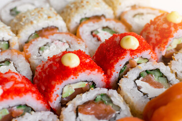 Fresh delicious sushi rolls. Rolls Philadelphia with salmon and California with tuna. Japanese cuisine background.