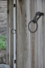 Close-up of rustic handle on old wooden doors. Cracked wood material structure. Selective focus. Byeongsan Seowon, Andong, South Korea.