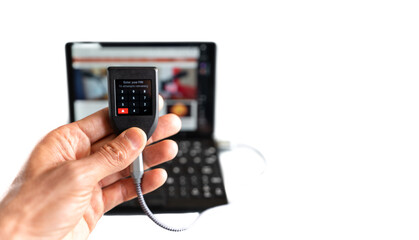 Digital wallet asking for pin with laptop in the background