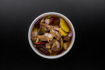 Spicy pork spare rib soup with herbs