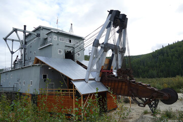 Fototapeta na wymiar Old historic rusty abandoned Gold Dredge n.4, Klondike Gold Rush, Bonanza Creek, Dawson City, Yukon, Canada