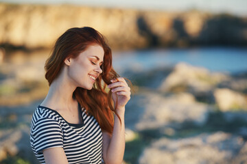 happy traveler in t-shirt are resting in the mountains near the river