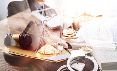 Justice and law concept.Male judge in a courtroom with the gavel, working with, computer and docking keyboard, eyeglasses, on table in morning light