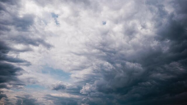 Gray Cumulus Clouds moves in the Blue Sky, Timelapse. Dramatic cloudscape time lapse. Dark Cirrus Storm clouds change shape. Majestic Amazing Sky. Layers of Cloud space. Change of weather. 4K