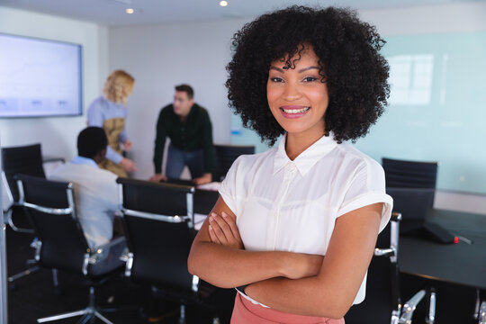Portrait of african american woman smiling while standing in the meeting room at modern office