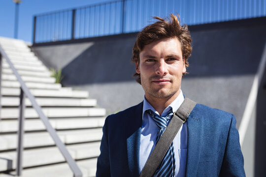Portrait of caucasian businessman looking at camera in the sun