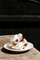 Cream dessert of airy Italian meringue. Party food concept, cafe. Place for text. Postcard for the holiday