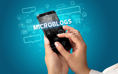 Hand using smartphone with social media concept