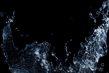 Splashing water on black background. Free space for text. Macro photo.