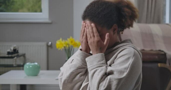 African American woman closing face making disgust facial expression. Young unhappy lady smelling unpleasant stink indoors at home. Cinema 4k ProRes HQ