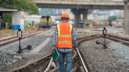 Back view engineer, worker walk on railway inspection. construction worker on railways. Engineer work on railway. rail, engineer, Infrastructure