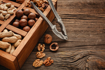 Various nuts on a wooden table. Top view with copy space.