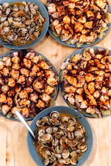 Different seafood dishes on the wooden table.