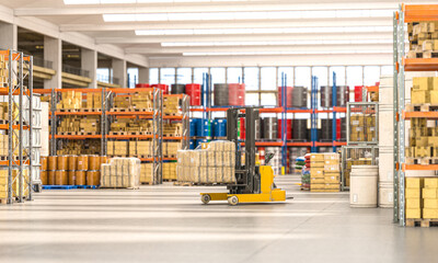 forklift truck that transports packages inside a factory. - obrazy, fototapety, plakaty