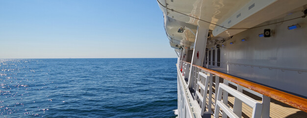 Relaxing and tranquil blue hour atmosphere on empty boat promenade deck of modern cruiseship or...