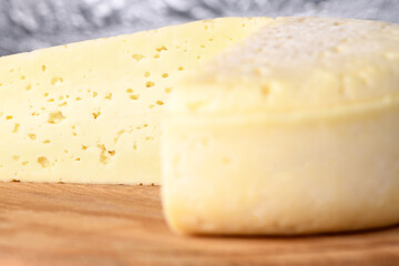Piece of cheese on wooden board. Homemade products