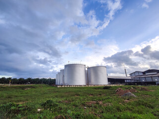 Fototapeta na wymiar Oil storage tank In industrial areas. Crude oil storage plant For export. Palm oil factories in Asia. Within the industrial plant. Zone tank storage industrial 