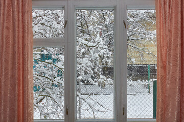 outside the old winter window,white wooden window with curtains and winter outside the window