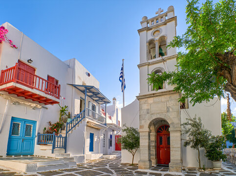 Megali Panagia or Metropolitan Greek Orthodox church of Mykonos, Cyclades, Greece in Alefkandra square. Greek flag, summer morning, calmness, relax