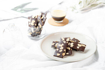 crunchy brittle brownie crisps crackers set on white cafe table.