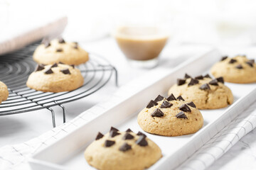 Delicious Whole Wheat Chocolate Chip Cookies set on white cafe table.