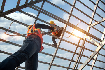 Construction workers install new roofs, roofing tools and fall protection devices. Apply to new...