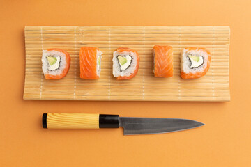 Sushi set sashimi and sushi rolls served on stone slate © Alina Zavhorodnii