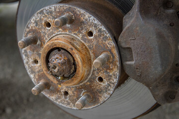 Removal of front wheel bearing on a passenger car. Dirty loud and rusty bearing in a front hub. Dismantling of a hub.