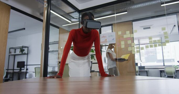 African american woman wearing vr headset at modern office
