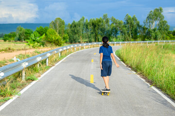 Fototapeta premium Child Play Skateboard on the Countryside Road