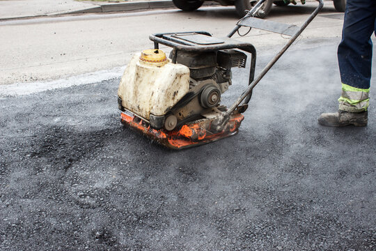asphalt rammer. laying the road surface