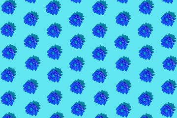 Creative minimal flat lay pattern art composition. Blue flowers against blue background. Creativ abstract concept art background.