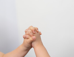 kid hands clench together in co operation teamwork concept