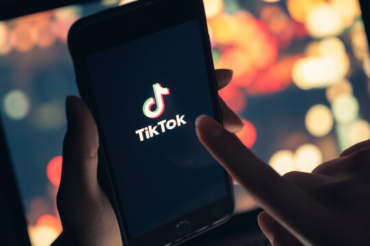 Tik Tok application icon on iPhone 11 pro max screen in hand and have a bokeh for background. Tiktok social media network.May 7, 2021, Bangkok, Thailand