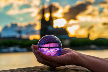 Close up of lensball at sunset in Cologne with Cologne Cathedral in background, Germany.