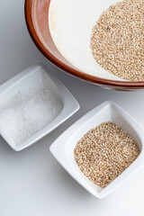 Preparation of gomashio (gomasio - sekihan seasoning ) with sesame seeds and salt in Suribachi (Japanese streak mortar). Top view.