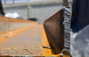 closeup of busy rusty steel girder for building construction