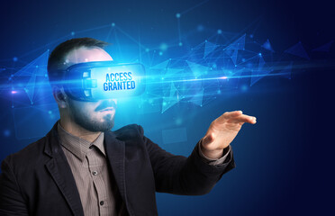 Businessman looking through Virtual Reality glasses, virtual security concept