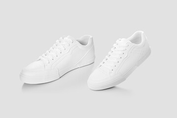 Mockup of a floating pair of sneakers walking against a plain background