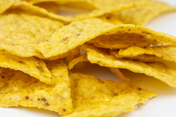 Close up, Triangular chips, mexican nachos, on white background. Perfect Tasty spicy snack for a beer.