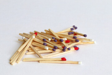 Colorful matches are scattered on a white background