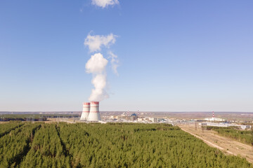 Cooling tower of Atomic power station with nuclear reactor. Industrial zone with Nuclear power plant with emission of steam in the air atmosphere.