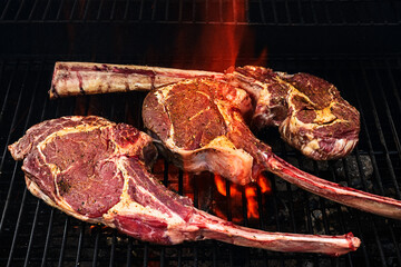 Tomahawk steak on the grill with flames