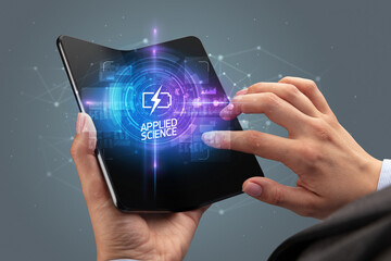 Businessman holding a foldable smartphone, technology concept