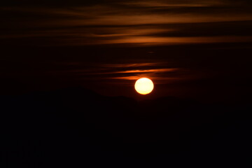Beautiful picture of orange big orange sun at the time of sunrise. dark orange sky in background. Selective focus, Selective Focus On Subject, Background Blur