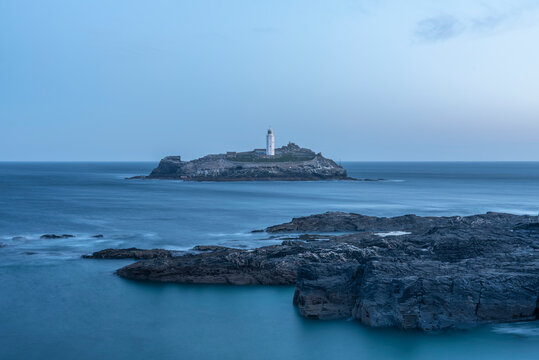 Beautiful and unusual landscape image of landmark Godrevy lighthouse on Cornwall's coastline