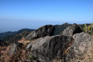 Big rocks on mountain. blue sky in background. Selective Focus On Subject, Background Blur