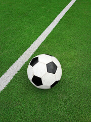 Football ball over green soccer field © breakingthewalls